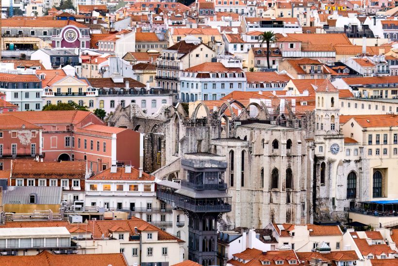 View of a city with red roofs and historic buildings.