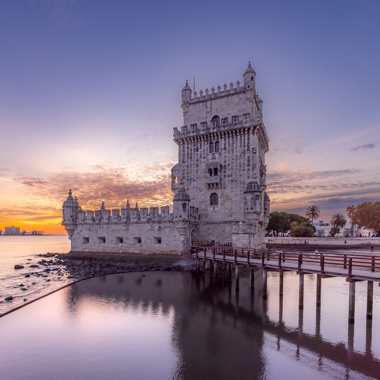 The Belém Tower in Lisbon during a colorful sunset.