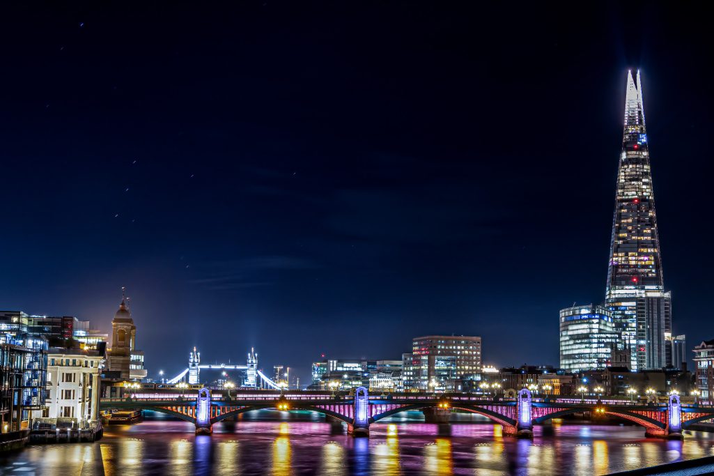 Night view of the Thames with illuminated bridges and the Shard in London.