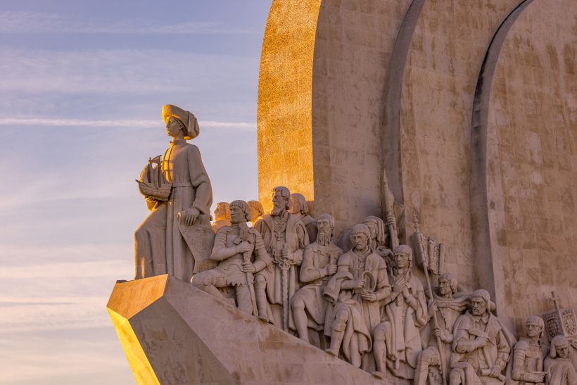 Sculpture group with historical figures and a figure in the foreground.